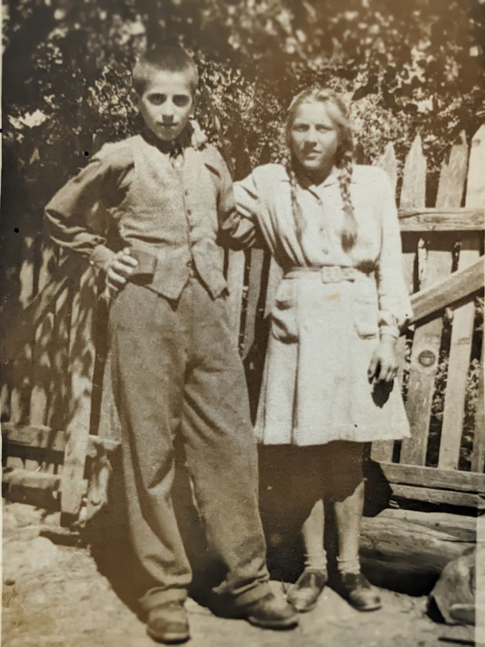 An old photograph of a woman with a child in a field.
